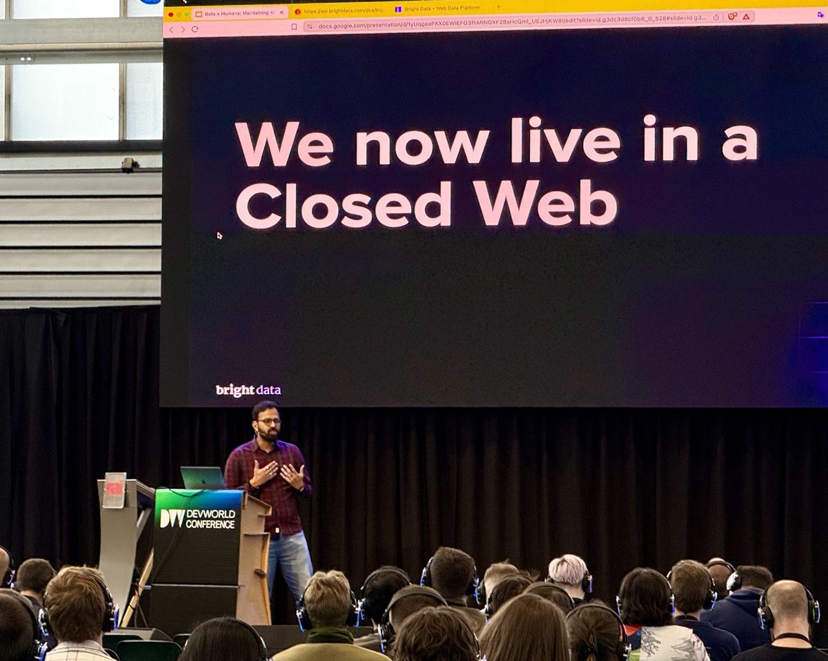 Anil on stage at devWorld Conference Amsterdam, slide reading "We now live in a Closed Web"